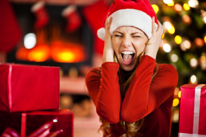 Young woman wearing Santa's hat is screaming.